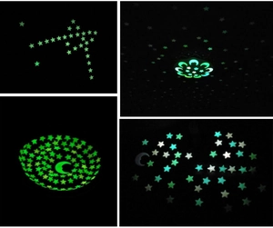 Detailed view of luminous moon and stars stickers glowing green in the dark bedroom