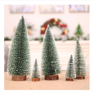 Miniature snow-flocked Christmas trees with solid wood bases for tabletop decoration