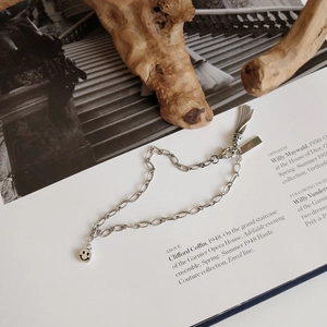 S925 sterling silver chain bracelet with retro smiley face pendant and tassel detail