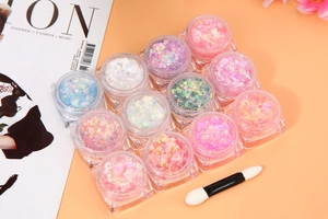Macro shot of 12-color glitter set with stars and sequins for professional makeup artistry