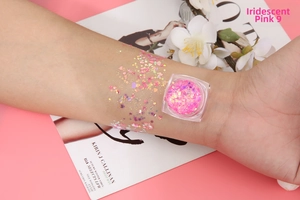 Chunky pink glitter gel for makeup and nails showing star and heart shapes on skin