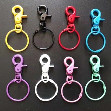 Eight colors of heart shaped painted metal alloy lobster clasps shown on black background