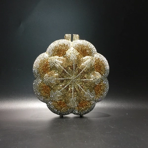 Detailed close-up of a floral evening clutch bag with intricate gold and silver rhinestones