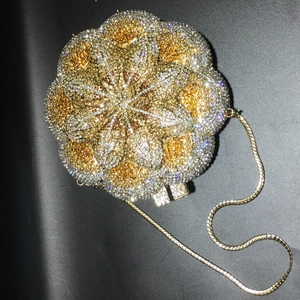 Macro shot of luxury rose-shaped evening bag featuring intricate gold and silver rhinestones
