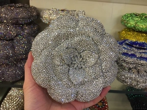 Close-up of a hollow rose flower evening bag encrusted with sparkling silver rhinestones
