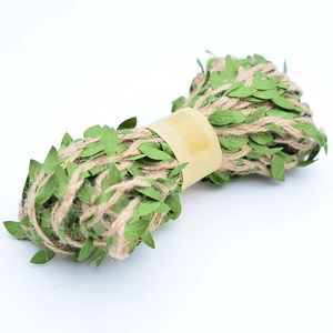 Close-up of artificial green leaf vine with natural jute twine for DIY crafts decor