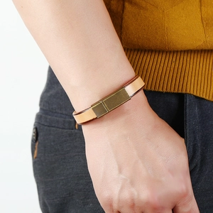 Men's stylish light brown leather bracelet with minimalist bronze metal clasp on wrist
