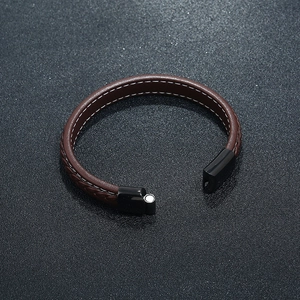 Brown braided leather magnetic bracelet with white stitching and black metal clasp