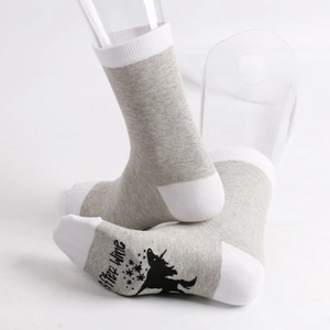 Detail of grey cotton socks featuring After Wine text and star silhouette on the sole