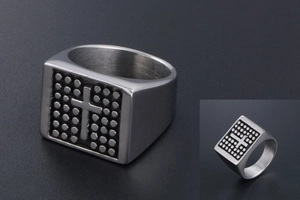 Macro view of vintage cross pattern and dot design on stainless steel signet ring for men