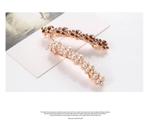 Detailed macro view of rose gold hair clips with brown crystals and white pearls