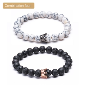 Detailed close-up of lava rock and marble beaded bracelets with micro-pave crown charms