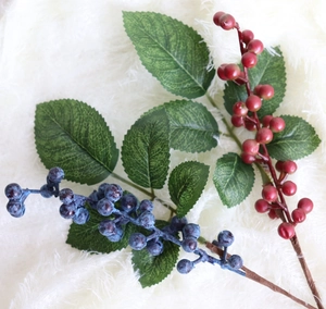 Close-up of realistic faux blueberry and red berry stems with natural frosted texture