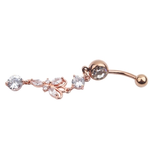 Macro detail of rose gold belly button ring featuring a bow and round zircon pendant