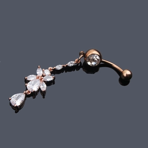 Macro shot of rose gold flower belly ring with marquise and teardrop zircon crystals