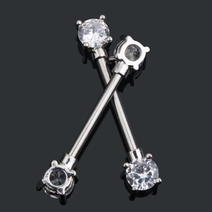 Macro detail of high-quality silver steel nipple rings with clear zircon crystals