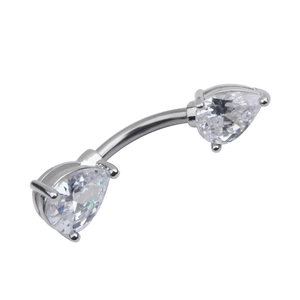 Macro detail of silver curved belly ring with teardrop cubic zirconia stones on white background
