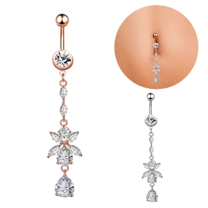 Detailed view of rose gold and silver flower drop navel rings with sparkling zircons
