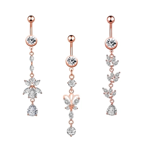 Rose gold belly rings with zircon flower, butterfly, and leaf pendants on white background