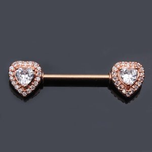 Macro view of rose gold nipple bar featuring double heart-shaped cubic zirconia studs