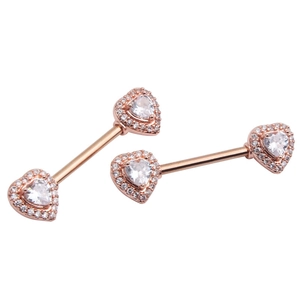 Close-up of rose gold nipple rings with heart-shaped sparkling zircon stones and pave detail