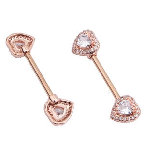 Detailed close-up of heart-shaped rose gold nipple rings with sparkling zircon inlay