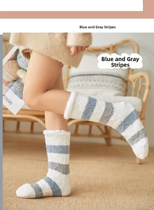 Detail of coral fleece winter socks with blue and grey stripes and soft plush texture