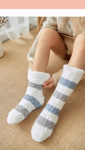 Close-up of soft coral fleece striped socks showing thick plush texture and warm material