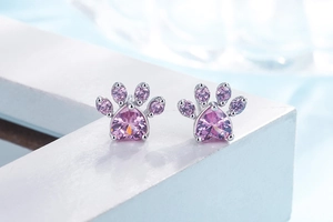 Detailed view of pink zircon cat paw studs in rose gold with heart-shaped gemstone
