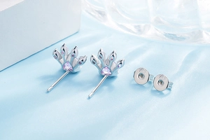 Close-up of 925 sterling silver paw print earrings with purple heart zirconia gems