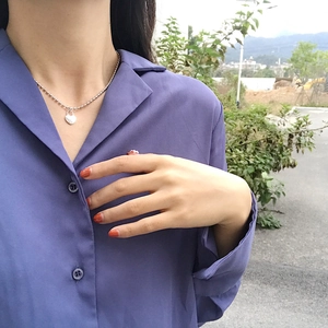 S925 sterling silver beaded necklace with heart pendant worn on model with blue shirt