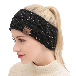 Detailed knit texture of a black confetti ear warmer headband with a C.C leather patch