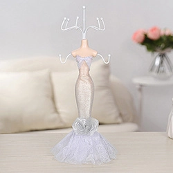 Detail of creative mannequin jewelry stand with metal hooks for necklace and earring storage