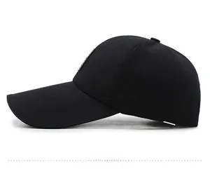 Side view of black cotton baseball cap showing structured crown and metal logo plate