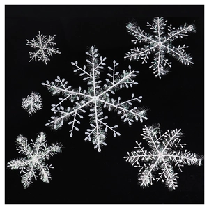 White Christmas snowflake hanging decorations with glitter texture for festive holiday trees