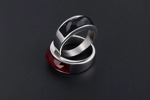 Detail of faceted black and red stone rings on polished stainless steel bridge bands