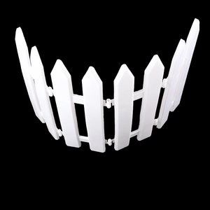 Detail of white plastic picket fence pieces linked by buckles for Christmas tree decor