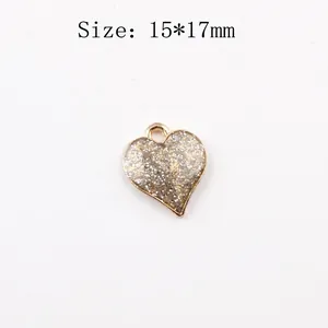 Detail of 15x17mm heart pendant with gold plating and silver glitter for DIY jewelry