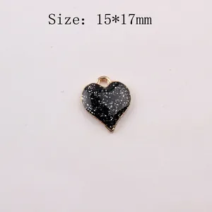 Detail of a 15x17mm black glitter heart pendant with gold-tone alloy edge for DIY jewelry