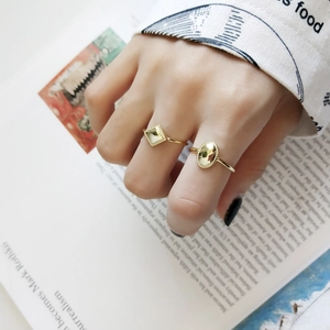 Detailed close-up of a 925 sterling silver adjustable golden geometric ring set on a hand