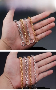 Macro detail of gold and silver plated O-shaped chain necklaces with secure OT toggle clasps