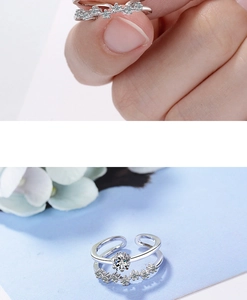 Close-up of silver-tone double-layer star rings with sparkling zircon inlays