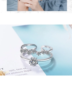 Detailed close-up of a double-layered star-shaped ring set with brilliant zircons