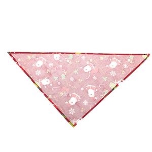 Close-up of red Christmas dog bandana with Santa Claus and snowflake pattern details