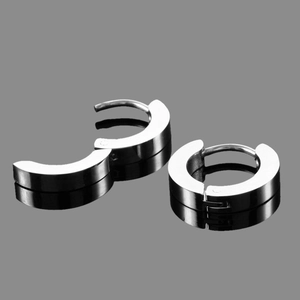Detailed macro view of silver stainless steel hoop earrings with hinged opening mechanism
