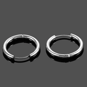 Close-up of silver stainless steel hoop earrings with polished finish and reflection