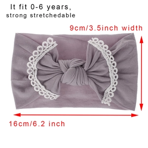 Soft lavender nylon baby headband with white lace bow detail for ages zero to six