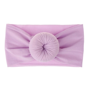 Dettaglio della fascia per neonati viola chiaro con un nodo decorativo su sfondo bianco