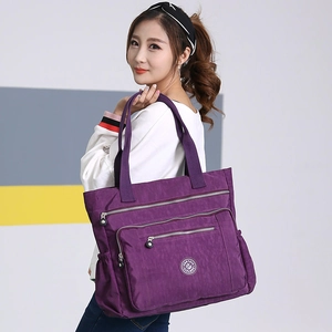 Purple nylon crossbody bag with multi-pockets shown on a model for casual daily style