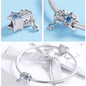 Detail of 925 sterling silver star charm with blue stones on a silver bracelet